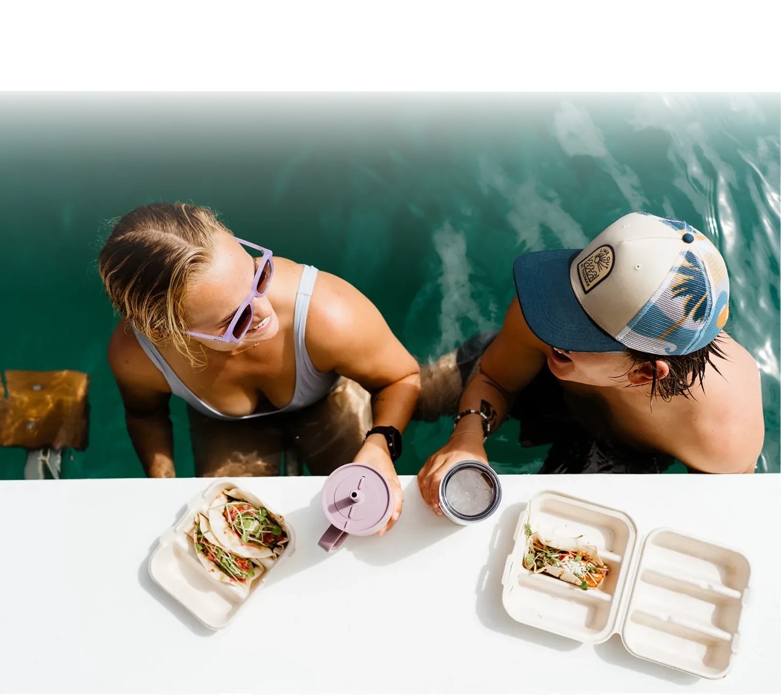Guests at the bar rail with tacos and cold drinks